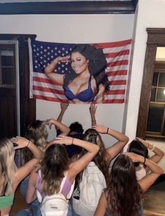 a group of girls standing in front of an american flag