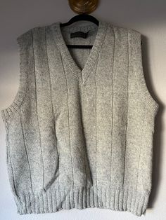 Vintage 90s Eddie Bauer sweater vest in heather gray. Marked as XL. 85% wool 15% nylon. Made in USA  No damage, rips, tears, or stains.  Measurements taken flat:  Neck to shoulder: 10" Chest: 25" Length: 28" Sleeve opening: 11" Gray Crew Neck Sweater Vest For Winter, Wool Sleeveless Sweater Vest, Casual Wool Sleeveless Sweater Vest, Casual Wool Sleeveless Vest, Casual Sleeveless Wool Vest, Gray Crew Neck Sweater Vest For Fall, Casual Wool Vest For Winter, Casual Sleeveless Wool Sweater, Gray Cotton Sweater Vest For Fall