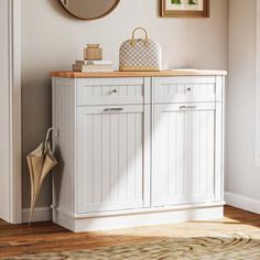 a white cabinet with two drawers and a mirror on the wall above it in a living room