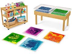 children's table and rugs with different colors on them