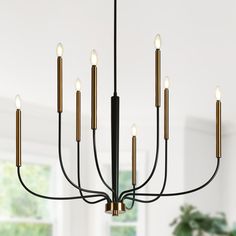 a black and gold chandelier hanging from a ceiling in a room with white walls