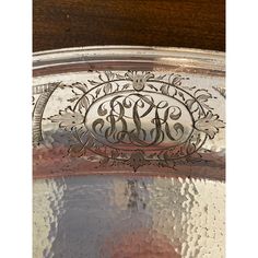 an ornate silver plate with the initials on it