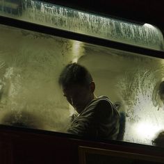 two people sitting on a train looking out the window