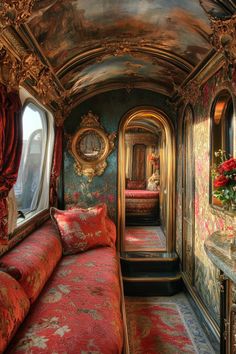 the interior of a train car is decorated in red and gold with flowers on the window sill