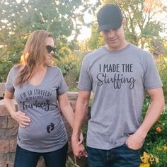 a man and woman standing next to each other wearing matching t - shirts that read i made the stuffing