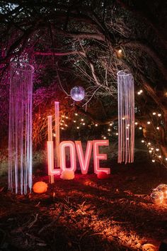 Bright pink neon 'LOVE' wedding sign Outdoor Disco Ball Wedding, Outdoor Disco Wedding, Outdoor Disco Party, Disco Balls Wedding, Neon Wedding Theme, Rave Wedding, 2026 Wedding, Festival Themed Party, 80s Wedding