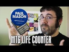 a man holding up a radio in front of his face with the words mtg life counter