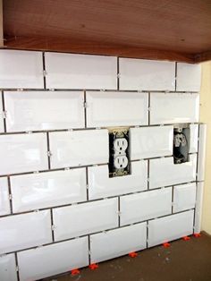 two black and white electrical outlets on a wall