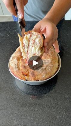 a person cutting up food on top of a plate with a knife and fork in it