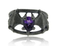 Amethyst Black Silver, Bat Ring Available for sizes 5-9 Blackened Sterling Silver 7x5mm Amethyst Amethyst Black Silver, Bat Ring -This bat won't fly around your head or echolocate. He's small and tidy and just the tiniest bit creepy-cute. Mounted on a solid split band style, he wraps around your finger about an inch, and is just half an inch wide. Total width with bands: 13mm, tapering to a comfortable 4mm on the bottom of the shank. Shown here blackened and set with a genuine oval amethyst, whi Bat Ring, Rough Gems, Vintage Engagement Rings Unique, Purple Band, Creepy Cute, February Birth Stone, Gothic Lolita, Vintage Engagement Rings, Fashion Rings