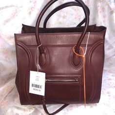 This Beautiful Brownish Red Celine Bag Is In Like-New Condition. It Has Been Pre-Loved, But Comes With Card Of Authenticity From Celine, Entrupy Certificate, And Original Celine Price Tag. Designer Burgundy Shopping Bag, Designer Burgundy Bag For Shopping, Designer Burgundy Shoulder Bag For Shopping, Designer Burgundy Shoulder Bag With Double Handle, Designer Burgundy Satchel For Shopping, Celine Mini Belt Bag, Celine Luggage Micro, Louis Vuitton Duffle Bag, Louis Vuitton Murakami