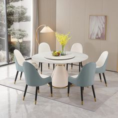 a white table with four chairs around it