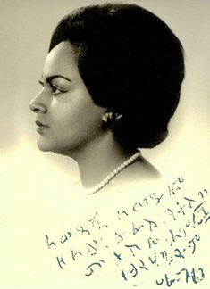 an old black and white photo of a woman with writing on the back of her head