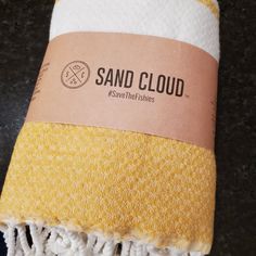 a yellow and white towel sitting on top of a counter