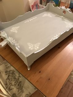 an empty white tray sitting on top of a wooden table