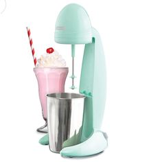 an ice cream sundae next to a blender with a strawberry milkshake in it