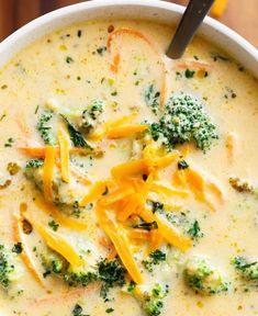 a white bowl filled with broccoli cheese soup