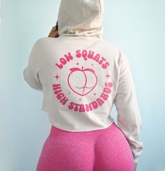 Low squats high standards hoodie. *Model is a size 6 and wearing a small.* *Heather dust gets pink text. All other colors get black or white text.* CROPPED HOODIE - 52% cotton and 48% poly-fleece - Drop shoulder and relaxed fit - Bella + Canvas brand - Size down if you're stuck between 2 sizes Fitted Sports Hoodie With Letter Print, Fitted Sporty Hoodie With Letter Print, Sporty Fitted Hoodie With Letter Print, Fitted Pink Hoodie For Streetwear, Fitted Pink Sweatshirt With Drawstring Hood, Pink Relaxed Fit Winter Activewear, Sporty Pink Gym Sweatshirt, Sporty Pink Sweatshirt For Gym, Fitted Hoodie Sweatshirt For Workout