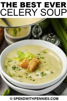 a bowl of soup with celery and bread croutons on the side