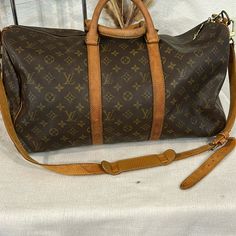 Used In Excellent Condition Normal Signs Of Wear Some Minor Stains On The Brown Leather . Minor Scoffing On At One Corner, Minor Cracks On The Strap No Tears. . Non Sticky. No Odor. Hardwares Are In Excellent Condition As Displayed In The Pictures And Video Louis Vuitton Bags, Authentic Louis Vuitton, Brown Gold, Travel Bags, Louis Vuitton Monogram, Louis Vuitton Bag, Picture Video, Brown Leather, 50 %