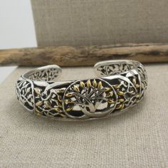 "Petite Tree of Life Bangle in Sterling Silver with 18K Accents. 2\" across a little less than a size 6 Front of Bracelet 5/8\"  Delicate Trees to the ends of the bangle. Nicely boxed for gift-giving with silver cloth Hinge opening. Keith Jack Jewelry Ships in 3 to 5 days. Ships Free within the USA 21 Day Returns Items must be returned in new unworn condition." Hallmarked Adjustable Cuff Bracelet For Gift, Adjustable Hallmarked Cuff Bracelet As Gift, Adjustable Hallmarked Cuff Bracelet Gift, Symbolic Round Cuff Bracelet Gift, Gift Sterling Silver Bracelet With Oxidized Finish, Luxury Round Cuff Bracelet As Gift, Luxury Round Cuff Bracelet For Gift, Luxury Round Cuff Bracelet Gift, Unique Gold Sterling Silver Bracelet As Gift