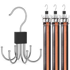 four orange and black crochet hooks are attached to the back of an electric fence