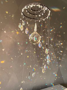 a chandelier hanging from the ceiling in front of a wall filled with bubbles