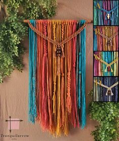 there is a multicolored wall hanging with beads and chains on it, next to some plants