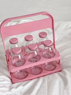 a pink plastic case filled with glass bottles