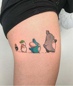 a woman's thigh with three cartoon characters on it