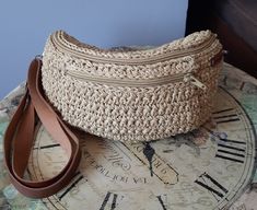 "Add a touch of uniqueness to your style and enjoy hands-free convenience with the \"Beige Waist (Freebag) Bag\". Revel in the elegance of crochet craftsmanship as every detail of this bag has been carefully designed for a distinct look. 📏 Measurements: Width: 25 cm 9,84 inches Height: 11 cm 4,33 inches Depth: 6 cm 2,36 inches Waist Circumference: One Size Fits All 🌟 **Features -Faux leather strap adds both style and comfort while carrying your bag. -Crocheted using eco-friendly double-layered recycled paper yarn, making it an environmentally conscious choice. -Lined interior helps you keep your belongings organized. -Front zippered pocket securely stores your essentials. -Zipper closure provides both security and practicality. This crochet bag is a blend of elegance and functionality, m Casual Handmade Bag With Adjustable Strap, Casual Handmade Bags With Adjustable Strap, Casual Handmade Adjustable Shoulder Bag, Casual Adjustable Handmade Shoulder Bag, Everyday Bohemian Pouch Straw Bag, Handmade Beige Pouch Beach Bag, Bohemian Crochet Mobile Phone Bag For Summer, Bohemian Crochet Bag With Removable Pouch For Travel, Bohemian Crochet Bag With Removable Pouch For Daily Use