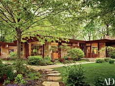 two pictures of the outside of a house with trees and bushes in front of it