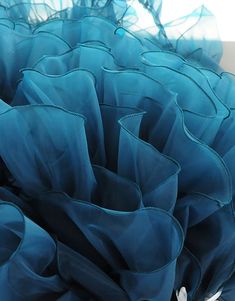 a close up of a blue ruffled object