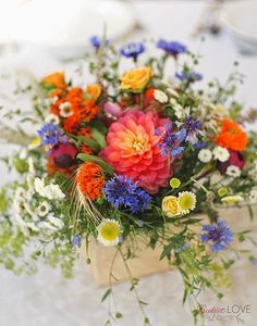 an arrangement of flowers in a vase on a table