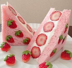 two slices of cake with strawberries on top