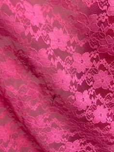 pink lace fabric with flowers on it