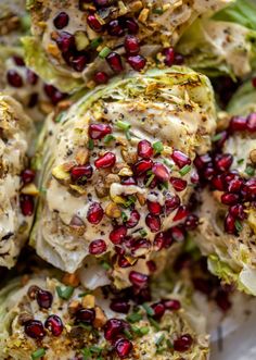 some broccoli with pomegranates and seeds on top of it