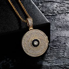 Eye-catching and definitely something different, this Photo Pendant Necklace is an interesting piece of jewelry that is sure to get noticed. The unique design features a locket pendant which can be opened to insert a photo of your choice. The locket is accented by a evil eye charm, believed to protect against negative energy and bad luck. The necklace is made of gold plated metal and the locket pendant hangs from a delicate chain of your choice. Whether you're looking for something different to Spiritual Jewelry With Round Pendant Chain, Spiritual Round Pendant Chain Jewelry, Black Amulet Locket Jewelry, Metal Medallion Chain Jewelry, Metal Medallion Jewelry With Chain, Amulet Style Charm Necklaces With Locket Pendant, Medallion Locket Charm Necklace In Amulet Style, Medallion Jewelry With Adjustable Chain For Keepsake, Keepsake Medallion Jewelry With Adjustable Chain