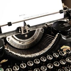 an old fashioned typewriter with a piece of paper on it