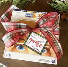 a box wrapped in plaid paper with a red bow