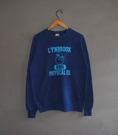 Up for sale cool Vintage 80s Lynbrook High School sweatshirt Used sweatshirt, show sign of wear, Overall still in good vintage condition (Please see picture) Tag size Adult Large with actual measurement taken when lying flat armpit 22 inches and 26 inches in total lenght (Approx) Please note that vintage sizing is not the same as modern sizing. Always go by the measurements we provide and compare them to an item that fits you well. Feel free to message me for measurements if you are not sure it Retro Crew Sweatshirt With Screen Print, Retro Crew Neck Sweatshirt With Screen Print, Vintage Cotton Sweatshirt For Campus, Vintage Winter Campus Sweatshirt, Retro Long Sleeve Pre-shrunk Sweatshirt, Vintage Graphic Print Sweatshirt For Campus, Retro Graphic Print Sweatshirt For College, Vintage Pre-shrunk Winter Sweatshirt, Vintage Sweatshirt With Letter Print For Campus