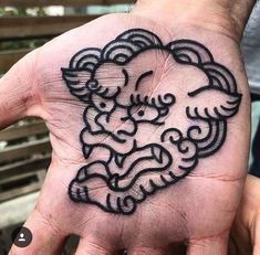 a person's hand with a tattoo on it that has an image of a sheep