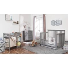 a baby's room with two cribs, a dresser and other furniture