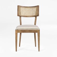 a wooden chair with a white seat and back cushion on top of it, in front of a white background