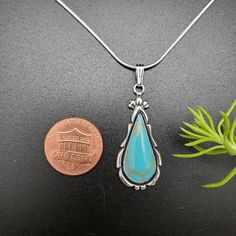 "Visit our on-line shop at: Etsy.com/shop/AlbuquerqueDesigns *sterling silver necklace pendant *long teardrop pendant with silver snack chain necklace 18\" *southwestern jewelry *kingman turquoise *calibrated pre-cut stones: 23x10mm teardrop shape *all jewelry items are made to ship, slight variations in stones will occur comparing to pictures. *size of a penny is 19mm or a dime is 18mm in diameter for comparing size with jewelry items. *handcrafted in USA *free small convenient gift box *free s Teardrop Turquoise Necklace With Large Pendant For Gift, Turquoise Teardrop Pendant Necklace, Sterling Silver Teardrop Turquoise Necklace, Sterling Silver Turquoise Teardrop Necklace, Nickel-free Teardrop Turquoise Sterling Silver Necklace, Southwestern Turquoise Teardrop Pendant Necklace, Nickel-free Teardrop Turquoise Necklace In Sterling Silver, Sterling Silver Turquoise Teardrop Necklace For Jewelry Making, Turquoise Heart Earrings