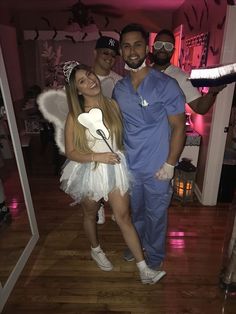 two men and a woman dressed up as tooth fairy dusters pose for a photo