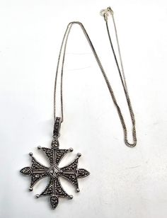 Maltese cross marcasite and rhinestone silver plated necklace. Good used condition with little to no signs of wear. No missing marcasite stones. Comes with sterling silver box chain. Necklace measures 19 inches long. Pendant measures 1 and 3/4ths of an inch tall and 1 and 1/4 of an inch wide. Antique Silver Sterling Silver Cross Pendant Necklace, Antique Silver Sterling Silver Cross Necklace, Antique Silver Cross Necklace In Sterling Silver, Antique Sterling Silver Cross Pendant Necklace, Silver Cross Necklace Stamped 925, Silver 925 Stamped Cross Necklace, Silver 925 Stamped Cross Pendant Necklace, Vintage Silver Sterling Silver Cross Necklace, Vintage Sterling Silver Cross Necklace