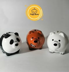 three ceramic piggy banks are sitting next to each other