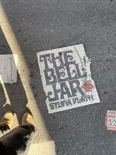 someone is standing on the sidewalk with their feet in the air and there is a sign that says the best jar