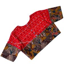 Add a touch of modern elegance to your wardrobe with this Red ikat cotton Blouse. The Pen Kalamkari Elephant border adds an exquisite detail, while the buttons on the back and sleeve edges provide a stylish twist. This blouse effortlessly captures a modish appeal that will elevate any outfit. Item : Blouse  material : Handloom  cotton Ikkat Size fits 36/42 ( Margins Included) Colour : Red Sleeve length :  10.5 inches Back Neck : High Neck Front Neck : 6.5 inches - U Neck Padding : No Lining : Ye Ikat Blouse Designs, Ikat Blouse, Applique Blouse, Fashion Blouse Design, Blouse Material, Women Tunic Tops, U Neck, Saree Look, Cotton Blouses